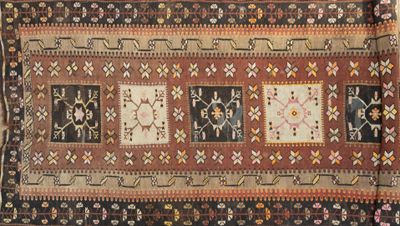 a brown and black rug with a pattern on it
