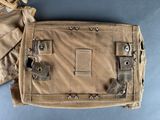 an image of a tan bag with a metal latch on it