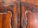 a large wooden armoire with carvings on it