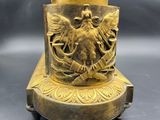 bronze statue of a man and woman on a pedestal with a bird on it