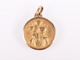 a close up of a gold medal with a jesus and mary on it