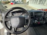 a steering wheel and dashboard of a truck in a parking lot