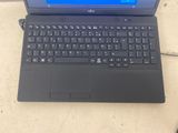 a black laptop with a blue screen sitting on a table