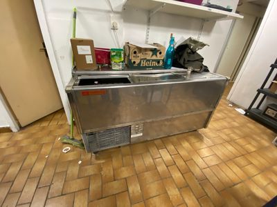 an image of a kitchen with a refrigerator and shelves