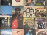 a lot of records on the wall of a room