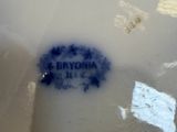 a white vase with a blue and white label on it