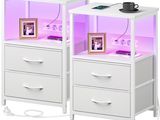 pair of white nightstands with purple lighting and pictures on them
