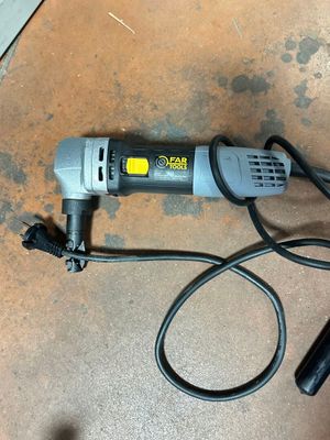 an image of a corded electric tool on the floor