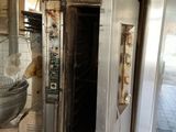 a dirty kitchen with a sink and oven in it