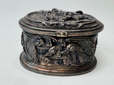 a silver box with a design on it on a white surface