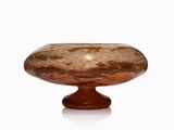 a glass bowl on a wooden stand on a white surface