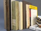several books are stacked on top of each other on a table