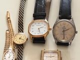 a lot of watches that are sitting on a table