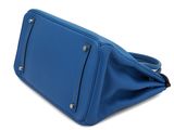 a blue purse with a zipper on the inside of it