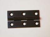 a black metal hinge on a white surface