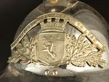 a silver helmet with a gold emblem on it