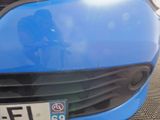a close up of a blue car with a number plate on it