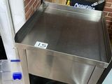 a stainless steel sink in the corner of a kitchen