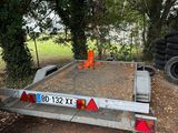 a trailer that is parked on the side of the road