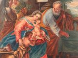 une image représentant un tableau où l'on voit un homme tenant un bébé dans une crèche