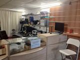 a picture of a small office with a desk and a chair