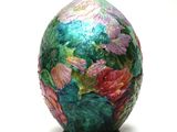 a colorful vase with flowers painted on it on a white surface