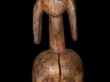 a wooden statue of a dog with a long neck and long legs