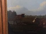 a painting of a cow and a cow laying down in a field