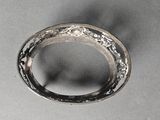 a close up of a silver ring on a table