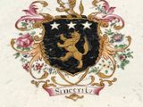 a white plate with a black and gold emblem on it