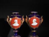 pair of royal blue and gold vases with a portrait of a man and a woman