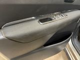 a cat sitting in the door of a car