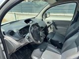 the interior of a small car with a steering wheel and dashboard