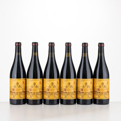 six bottles of wine are lined up on a table