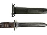 an image of a knife with a black handle on a white background