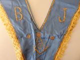 an image of a blue and gold masonic sash with gold fringes