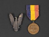two medals are shown next to each other on a black surface