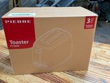 a cardboard box on a table with a toaster in it