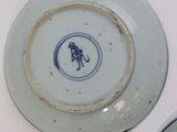 two plates that are sitting on a white table