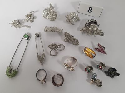 many different types of jewelry displayed on a white surface