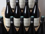 many bottles of wine sitting on a wooden crate