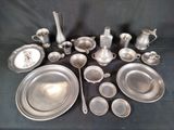 a lot of silverware on a table with a clock in the background