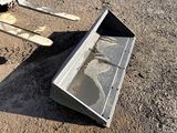 a metal box that is sitting on the ground