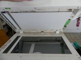 a person that is opening the top of a printer