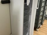 un réfrigérateur blanc dont la porte est ouverte, dans une pièce