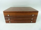 an image of a wooden box with three drawers on it