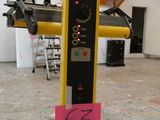 un poteau jaune et noir sur lequel est collé un autocollant rose
