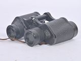 an old pair of binoculars sitting on top of a white surface