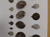 a man standing in front of a wall with a bunch of coins on it