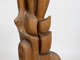 wooden sculpture of a hand holding a bunch of flowers on a white background
